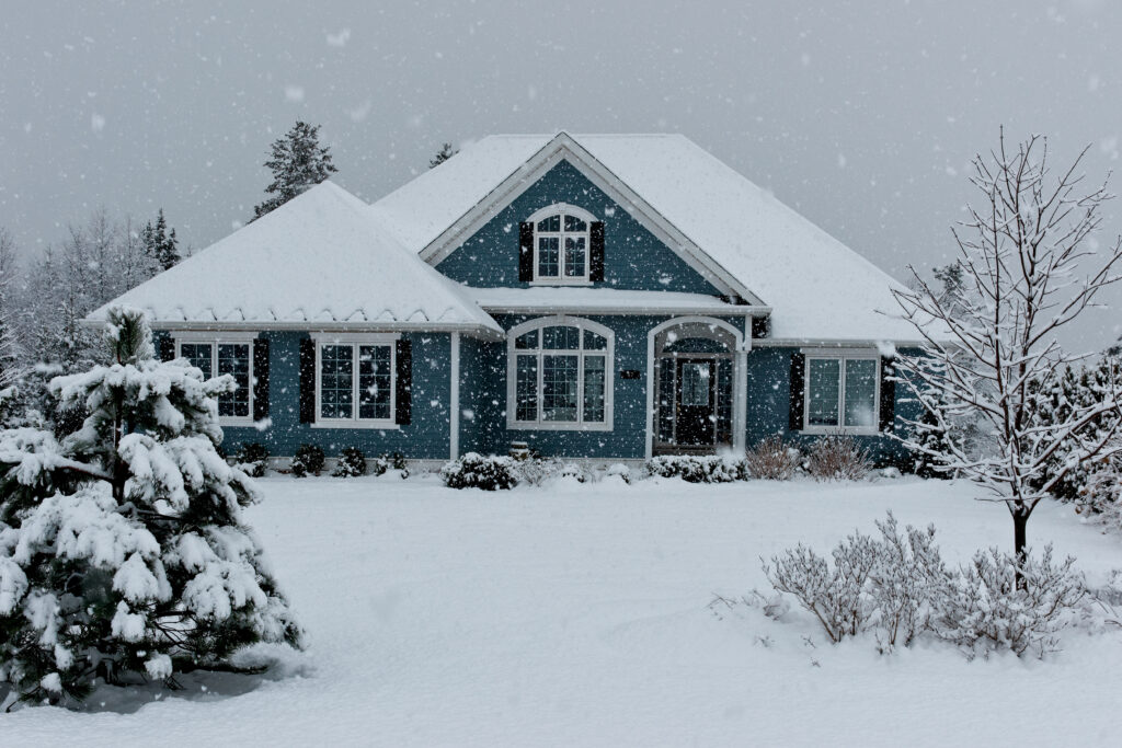 Front view of a house under moderate snow