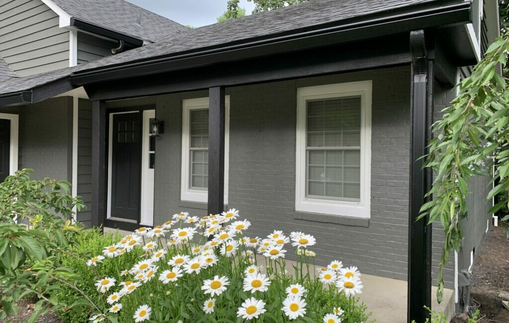 Home with black K-Guard Gutters Showcasing Downspout